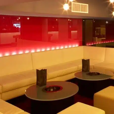 Nightclub with red and black glass on the walls.